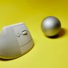 modern vertical mouse and ball on yellow background